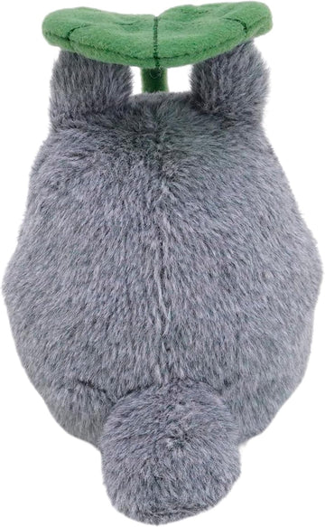 Plush toy resembling a gray creature with a green leaf on its back against a white background